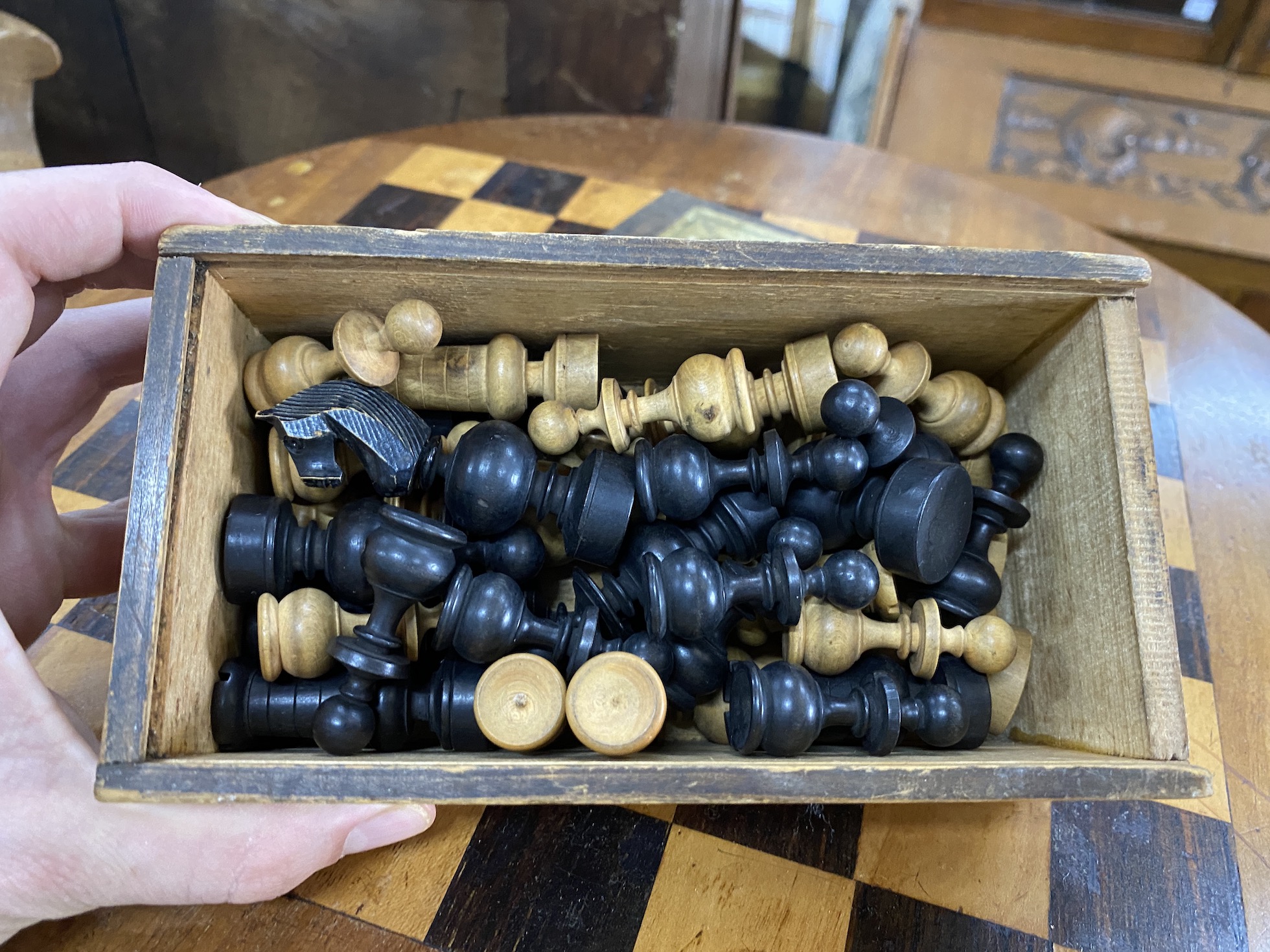 A Victorian inlaid walnut circular tripod games table, diameter 49cm, height 69cm together with a box wood chess set